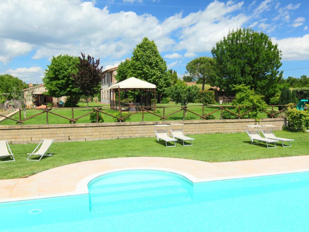 a group of chairs and a swimming pool at Apartment Il Cerro by Interhome in Trevinano