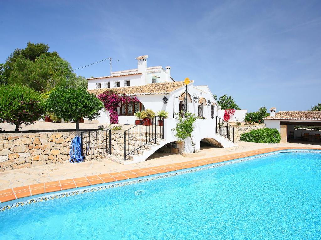 a house with a swimming pool in front of a house at Holiday Home El Baile Del Sol by Interhome in Pedramala