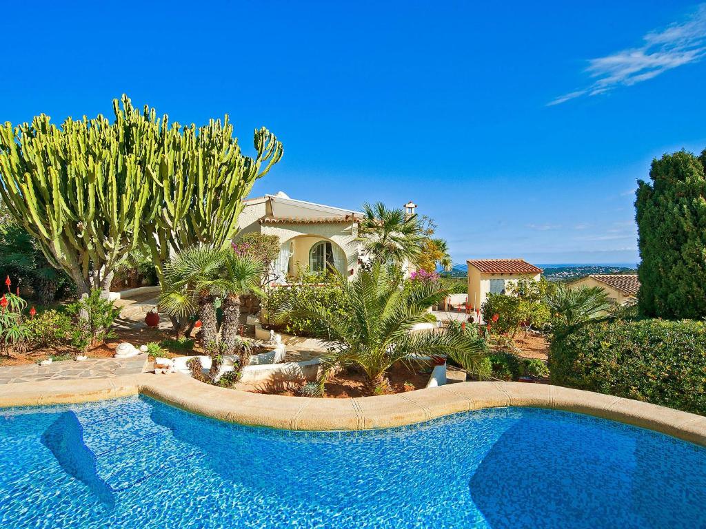 a large swimming pool in front of a house at Holiday Home La Caissa by Interhome in Benitachell