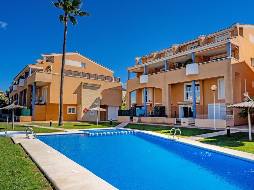 a swimming pool in front of a building at Apartment Menorca-3 by Interhome in Balcon del Mar