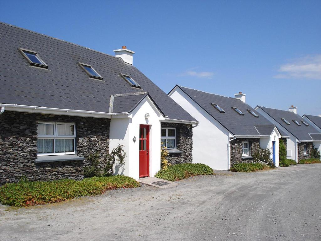 a row of houses with a red door at Holiday Home Seaside Cottages-1 in Valentia Island