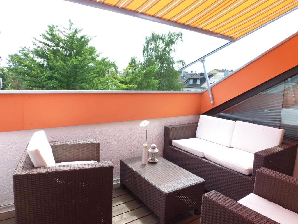 an outdoor patio with two chairs and a table at Apartment Weisenhorn by Interhome in Bötzingen