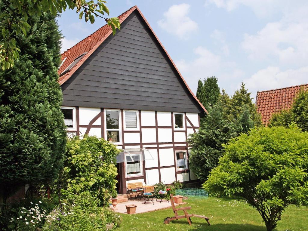 a white and black house with a black roof at Apartment Kopei by Interhome in Eschenbruch