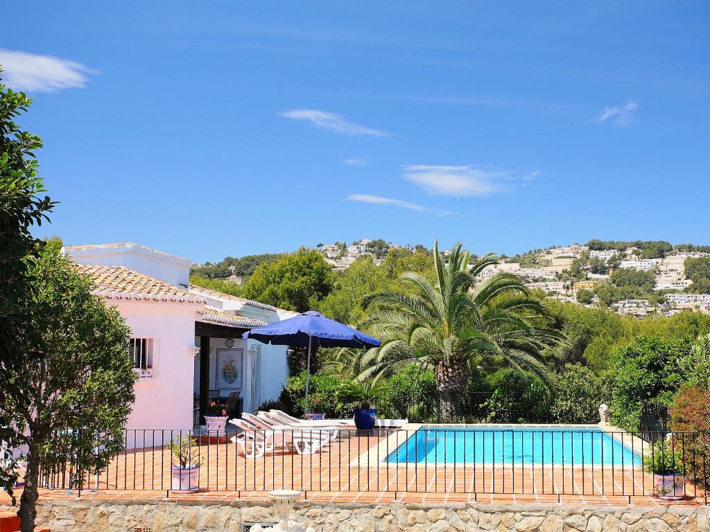 a villa with a swimming pool and a house at Holiday Home Krumel by Interhome in Moraira