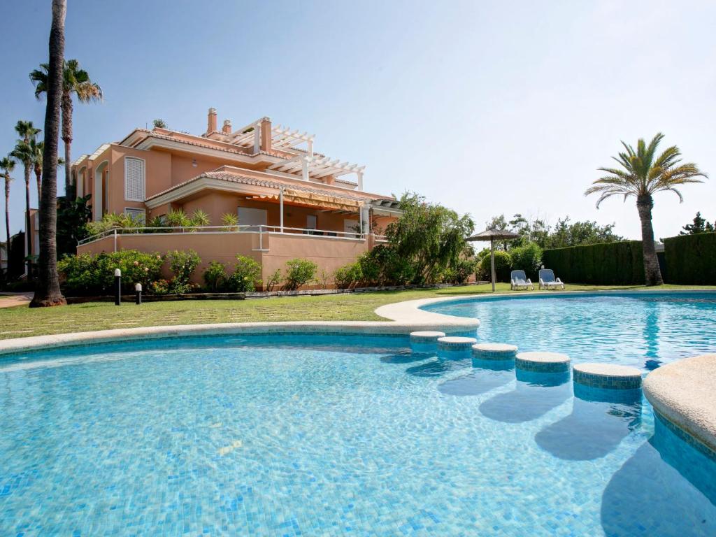 a swimming pool with a house in the background at Apartment Keops by Interhome in Casas Devesa