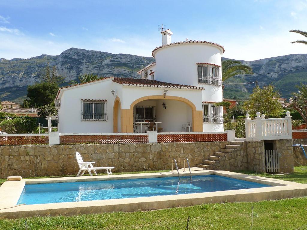 a villa with a swimming pool in front of a house at Holiday Home Pia by Interhome in Denia