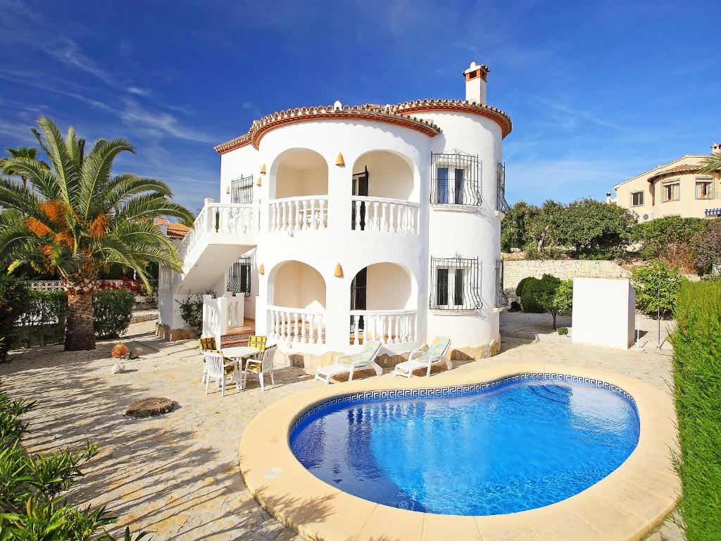 a house with a swimming pool in front of it at Holiday Home Pla del Mar by Interhome in Moraira