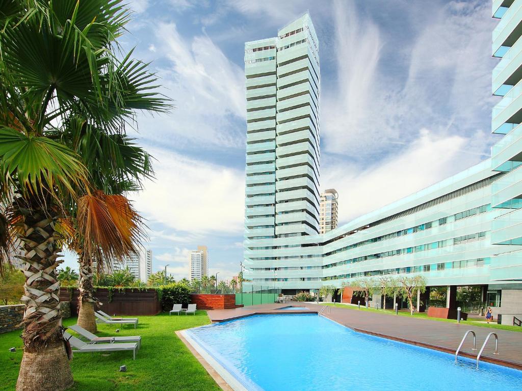 a tall building with a swimming pool in front of a building at Apartment Diagonal Mar by Interhome in Barcelona