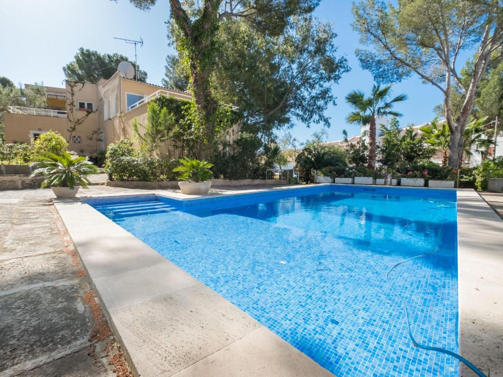 una piscina frente a una casa con árboles en Villa Santa Ponça by Interhome, en Santa Ponsa