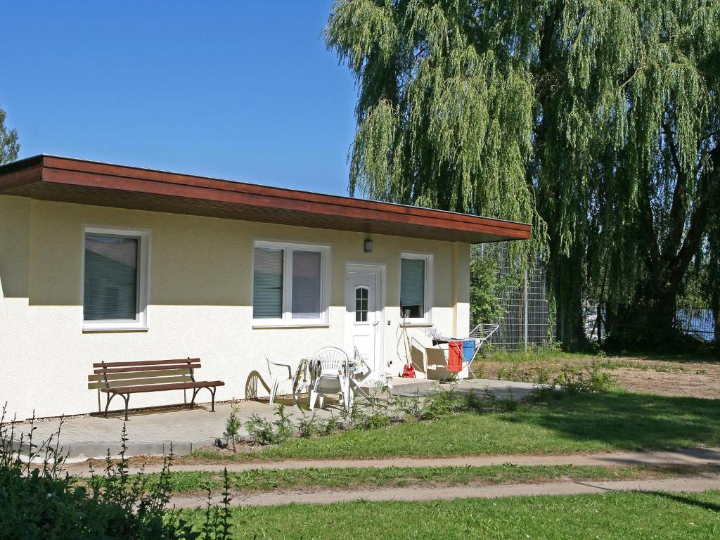 a house with a bench and a picnic table in front of it at Holiday Home Goetheallee by Interhome in Krakow am See