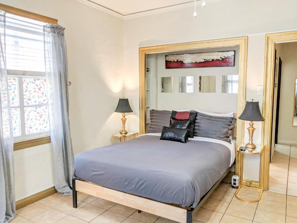 a bedroom with a large bed and a window at Casa Bonita Apartments in Long Beach