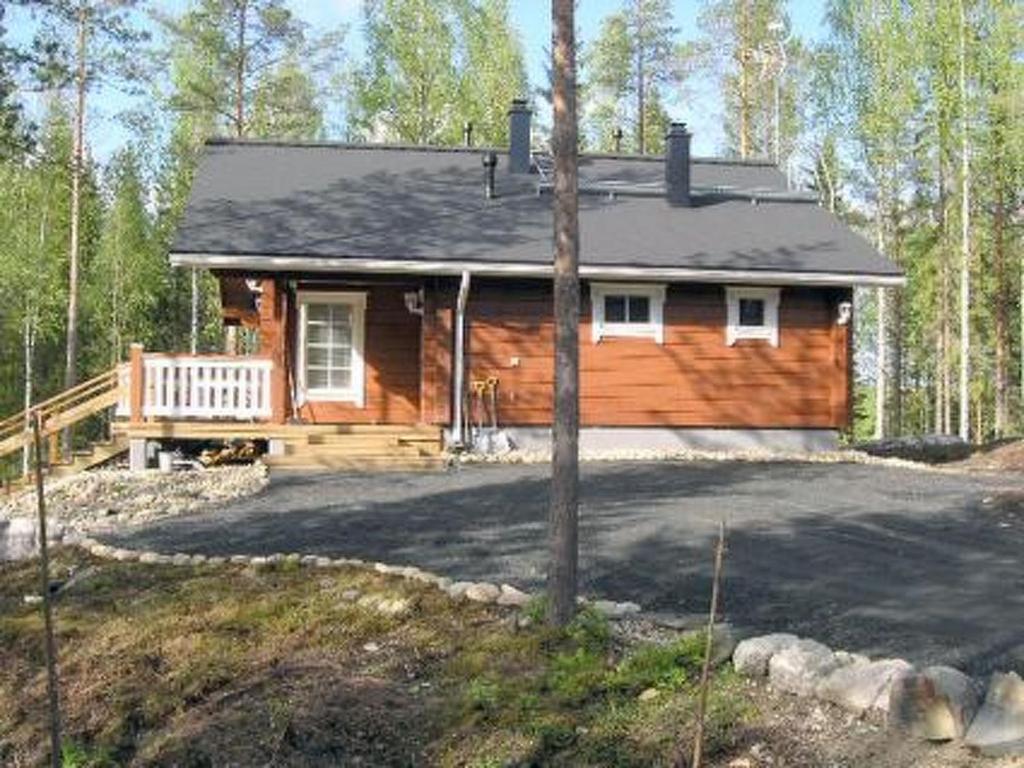 a wooden house in the middle of a forest at Holiday Home Syvälahti by Interhome in Sonkajärvi