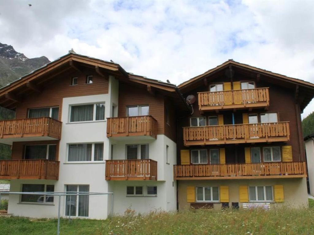 ein Apartmenthaus mit Holzbalkonen darauf in der Unterkunft Apartment Weideli by Interhome in Saas-Grund