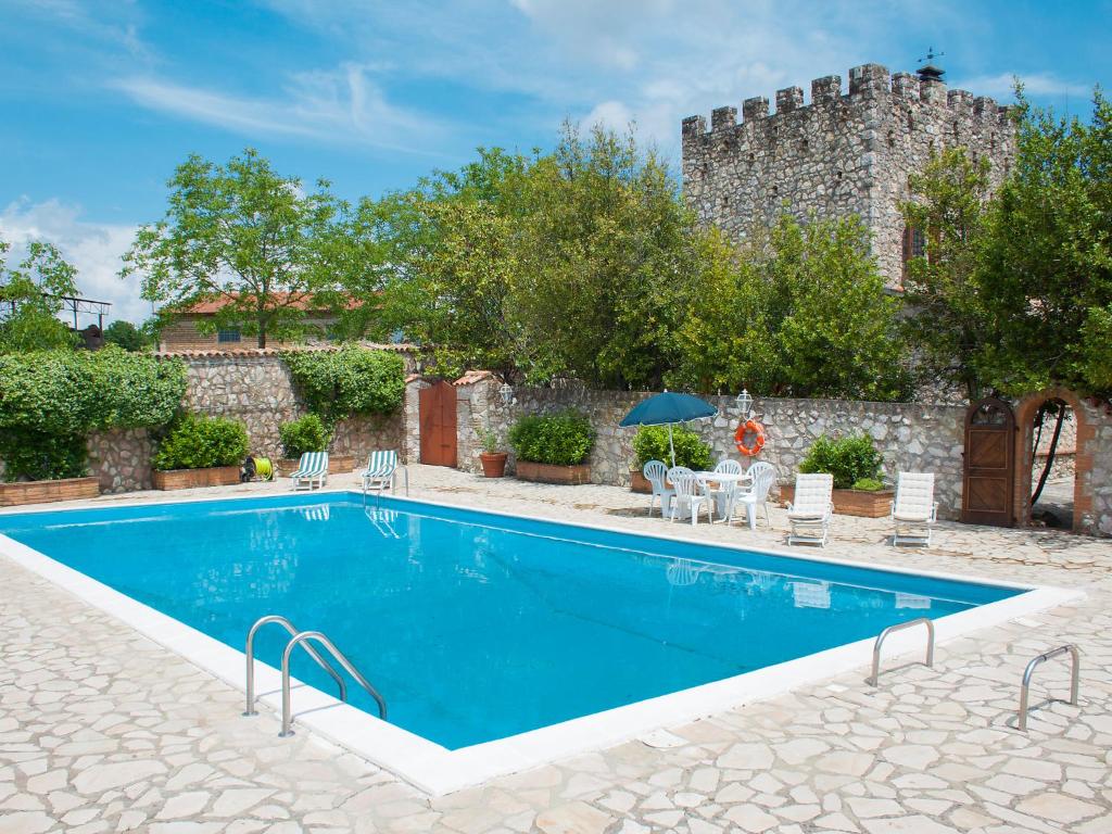 einem Pool vor einem Gebäude mit einem Schloss in der Unterkunft Villa Olivo secolare by Interhome in Castelrinaldi