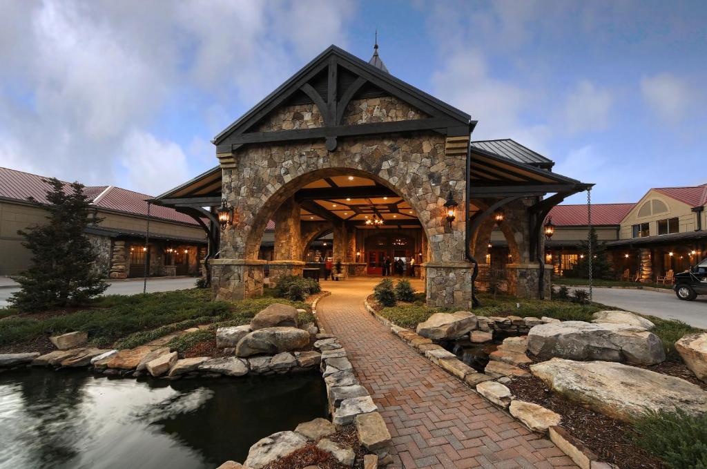 a large building with a river in front of it at Lanier Islands Legacy Lodge in Buford