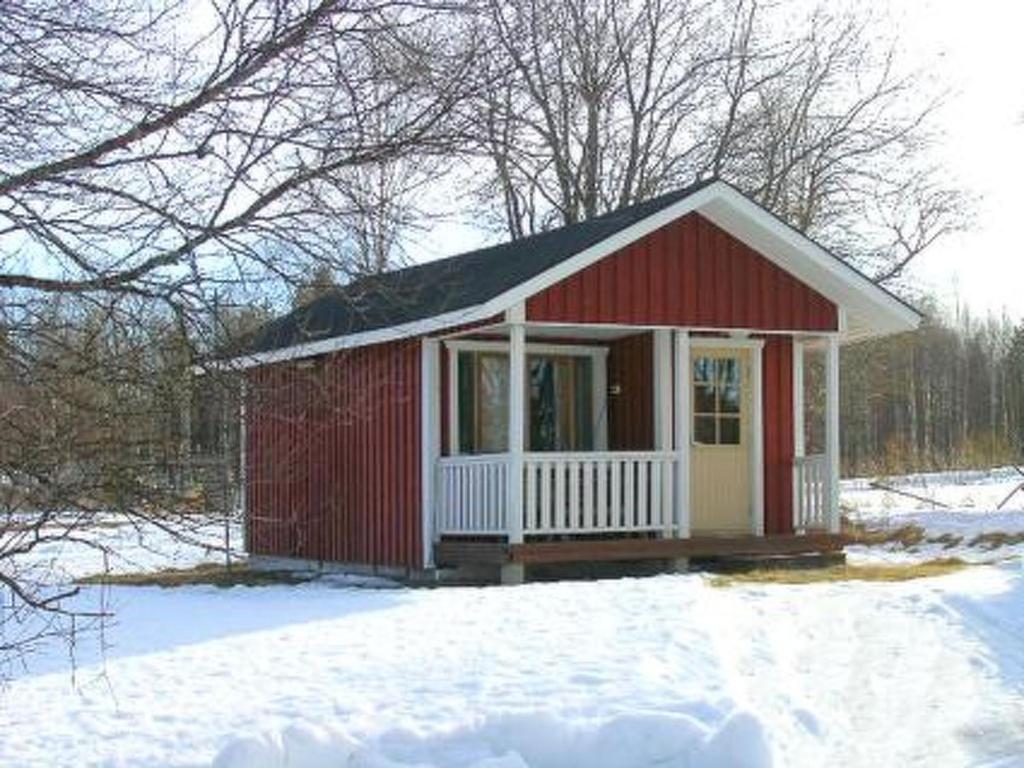 a small red shed with snow on the ground at Holiday Home Karpalo by Interhome in Jokijärvi