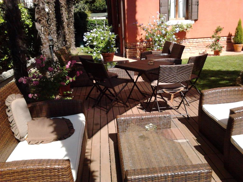 a patio with chairs and a table and a table and chairs at Villa Casanova in Venice-Lido