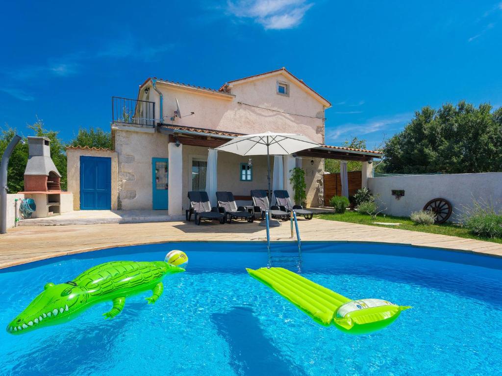 a pool with a inflatable frog in the middle of a house at Holiday Home Stefanina by Interhome in Labin