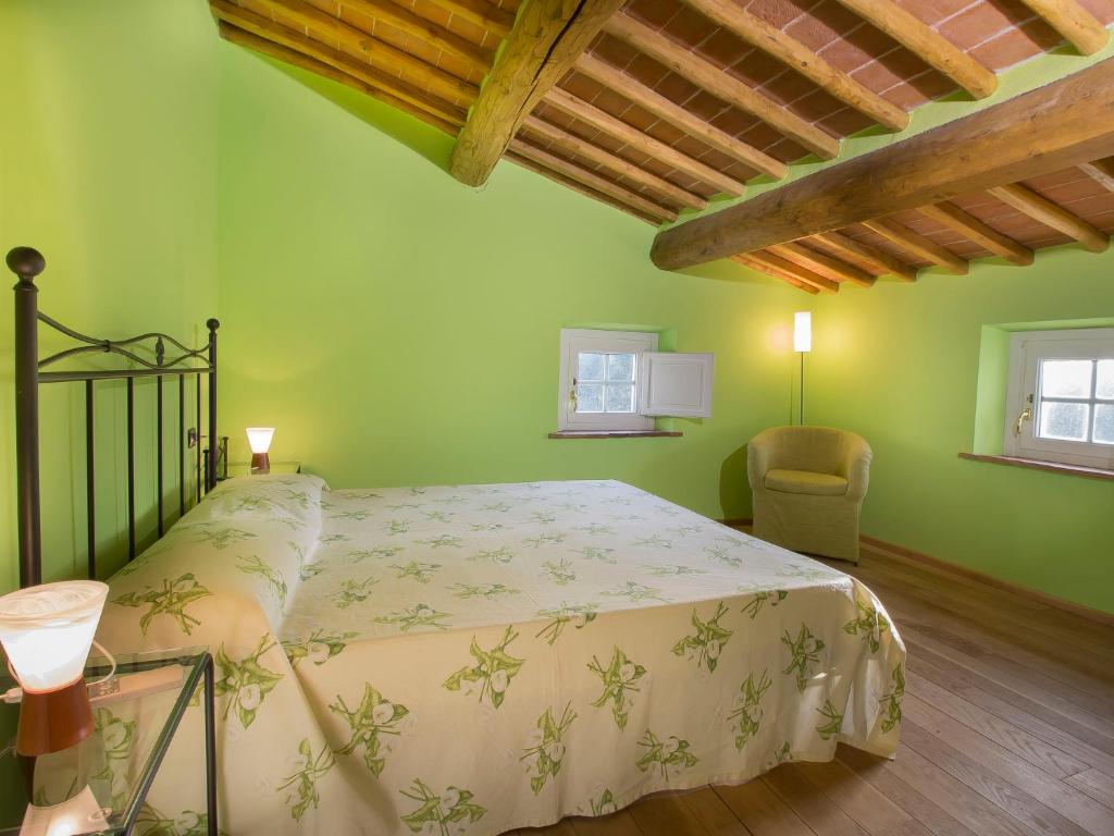 A bed or beds in a room at Holiday Home Villa il Pellicano by Interhome
