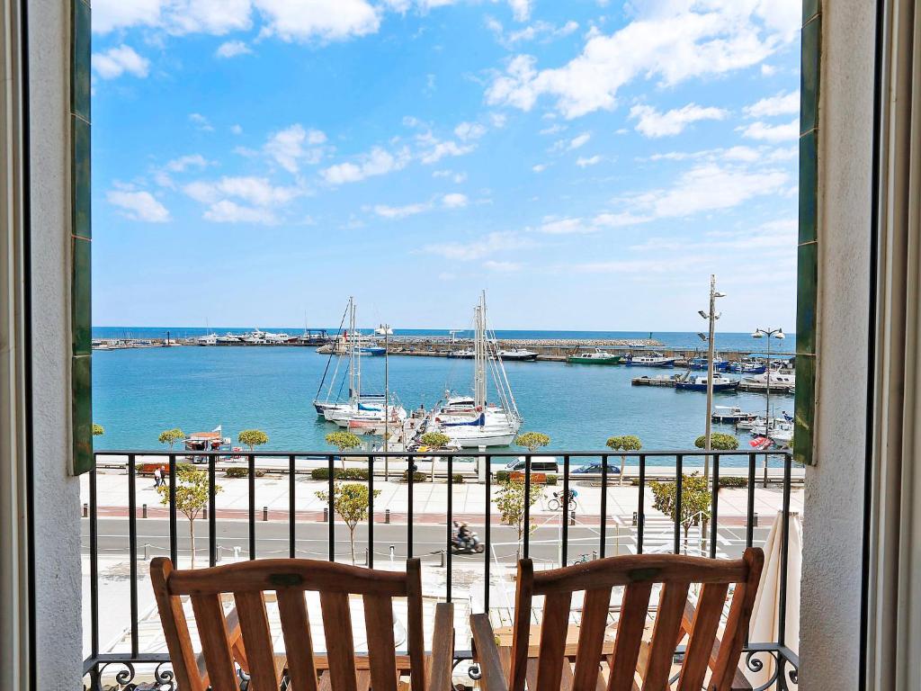 a view of a harbor from a window with two chairs at Apartment Cambrils Port by Interhome in Cambrils