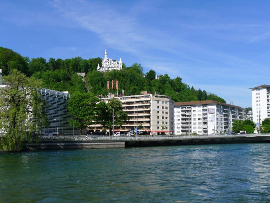 a view of a river with buildings and a city at Apartment BHMS City Campus by Interhome in Luzern