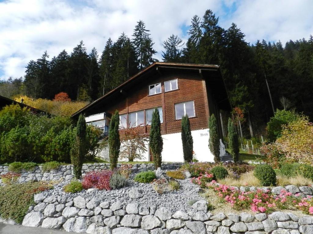 a house with a rock garden in front of it at Apartment Weidli- Chalet by Interhome in Zweisimmen