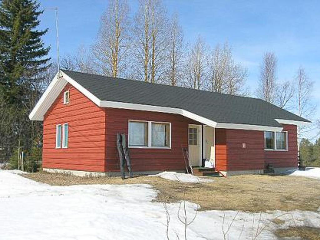 a small red house with a black roof at Holiday Home Herkkola by Interhome in Jokijärvi