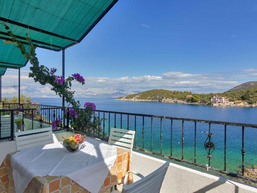 a table on a balcony with a view of the water at Apartment Rubin-11 by Interhome in Selca kod Bogomolja