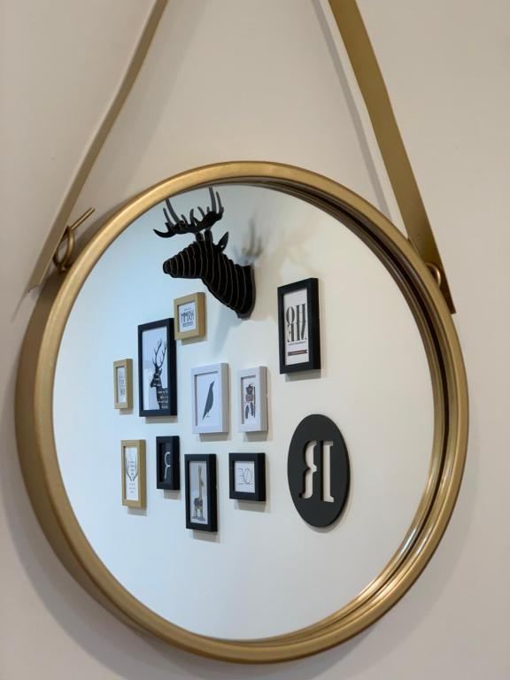 a mirror with pictures and a deer on the wall at 里舍民宿 in Jincheng