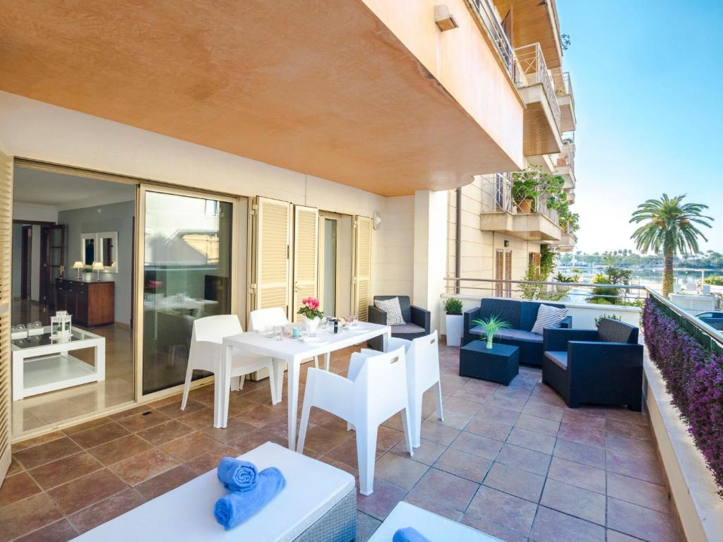 a patio with a table and chairs on a balcony at Apartment Maritimo by Interhome in Port d'Alcudia