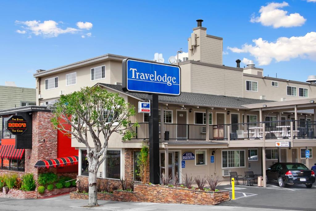 a sign for a hotel in front of a building at Travelodge by Wyndham San Francisco Bay in San Francisco