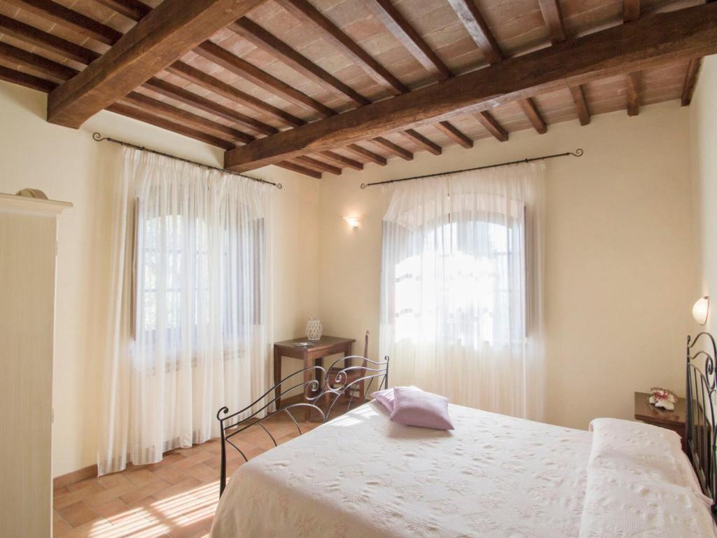A bed or beds in a room at Holiday Home Montecucco Winery by Interhome