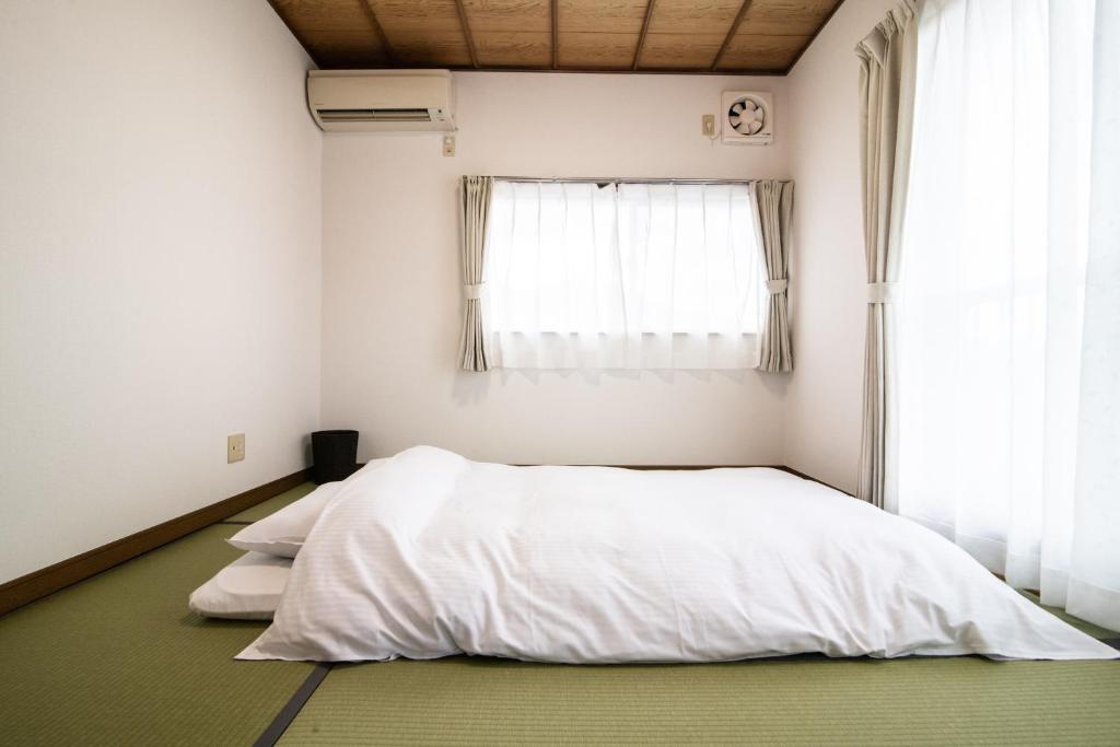 Postel nebo postele na pokoji v ubytování Yufuin Yukari-an Megumi no Sato