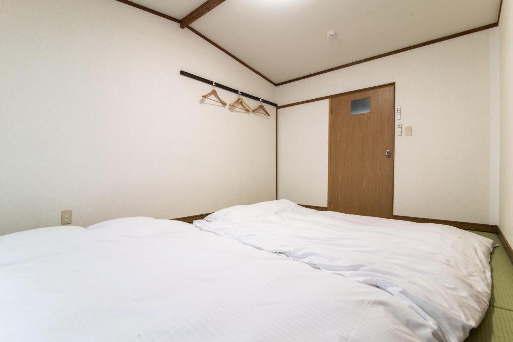 Postel nebo postele na pokoji v ubytování Yufuin Yukari-an Megumi no Sato
