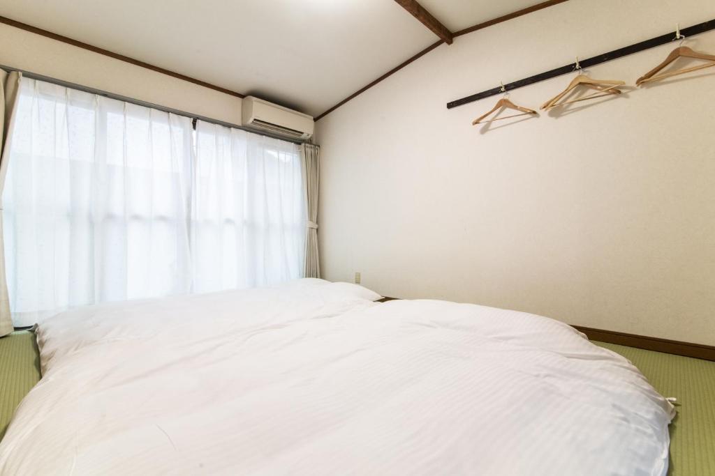 Postel nebo postele na pokoji v ubytování Yufuin Yukari-an Megumi no Sato