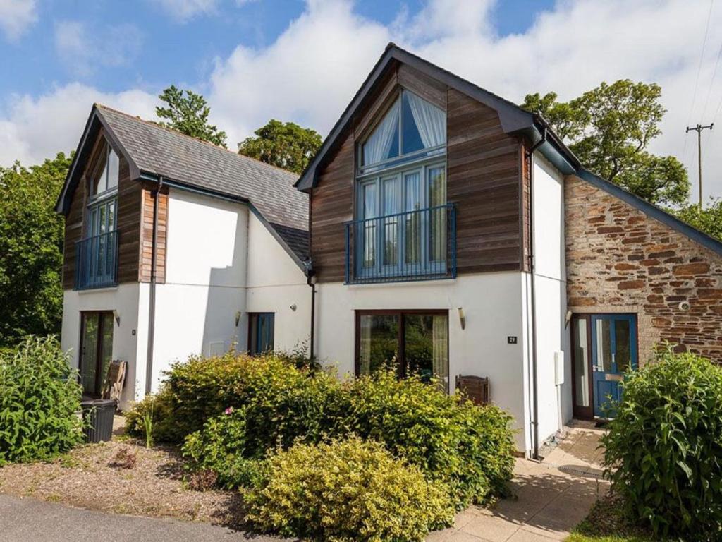 a white house with a black roof at Holiday Home The Valley by Interhome in Perranwell