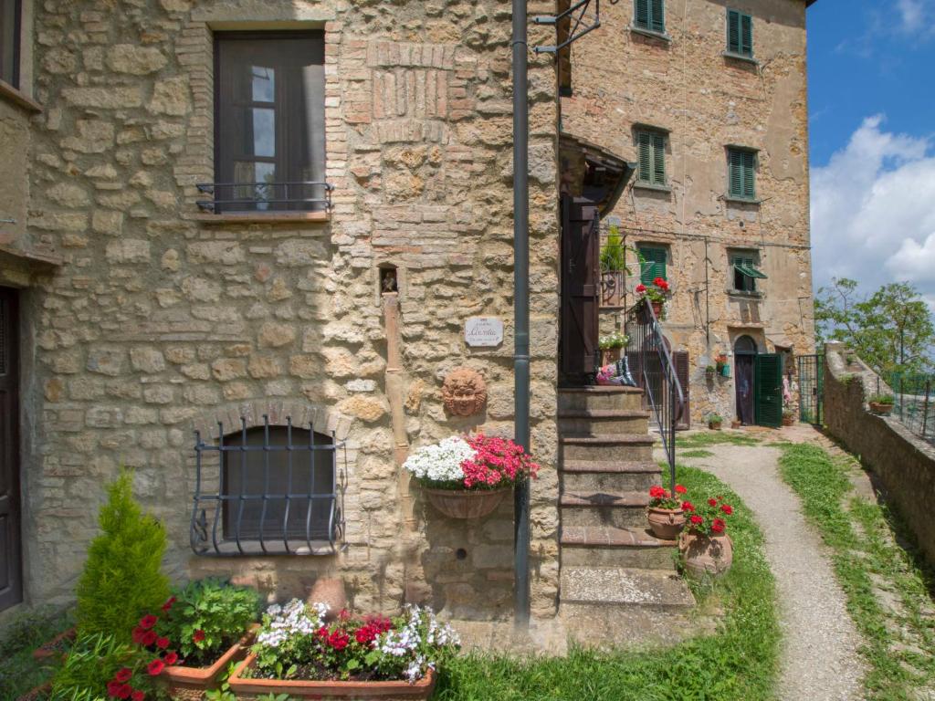 ein Steingebäude mit Blumen davor in der Unterkunft Apartment La Fonte by Interhome in Volterra