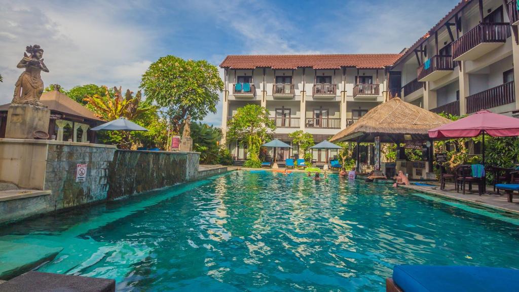 a swimming pool in front of a hotel at The Lokha Legian Resort & Spa in Legian