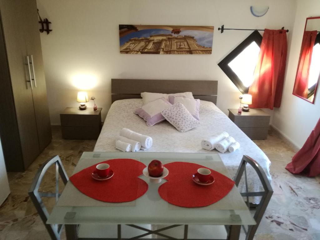 a bedroom with a bed and a table with cups on it at B&B Vista Gallipoli in Alezio