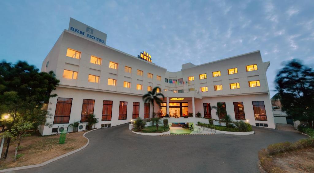a large white building with a lot of windows at SRM Hotel in Tuticorin