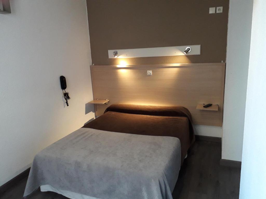 Postel nebo postele na pokoji v ubytování Hotel Le Terminus