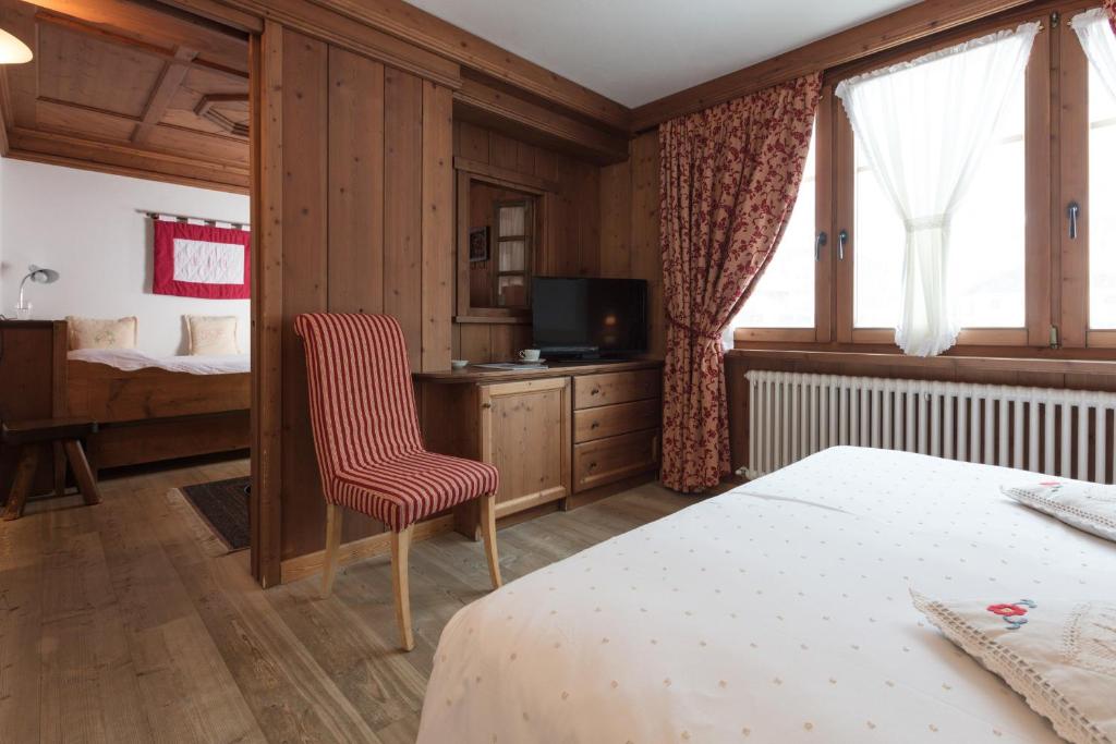 Postel nebo postele na pokoji v ubytování Hotel Baita Fiorita