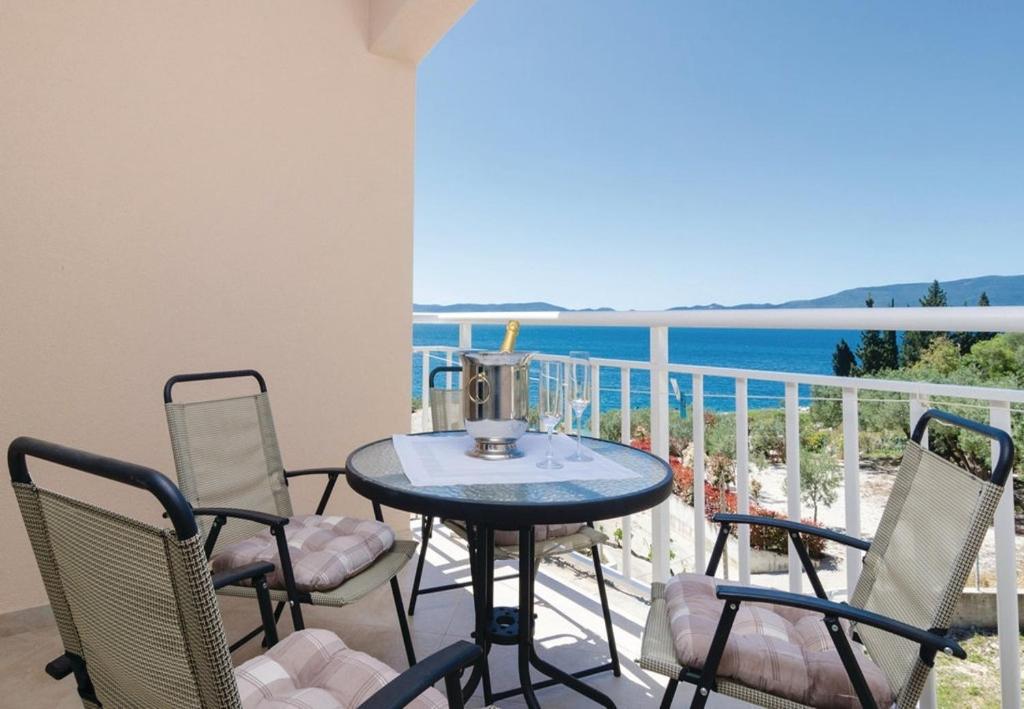 einen Tisch und Stühle auf einem Balkon mit Meerblick in der Unterkunft Apartments Ljuba - in center & close to the beach in Duba