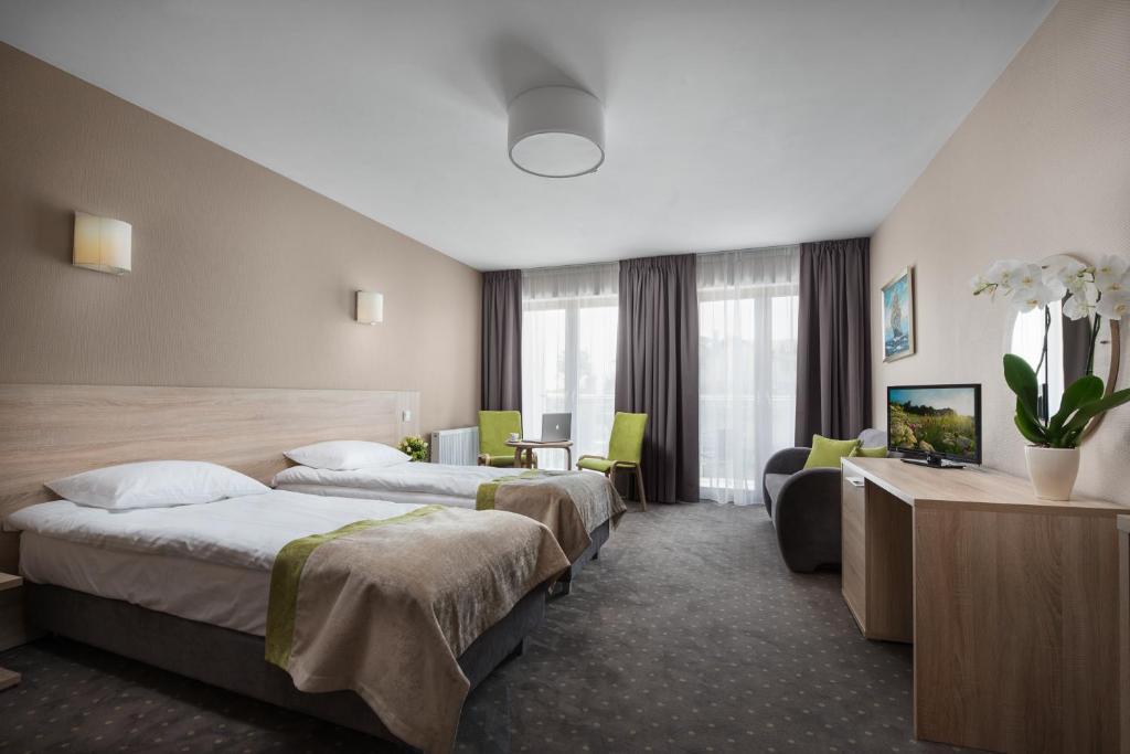 Postel nebo postele na pokoji v ubytování Hotel Szafir