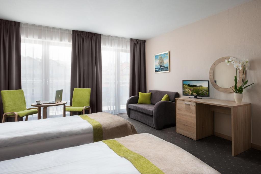 Postel nebo postele na pokoji v ubytování Hotel Szafir