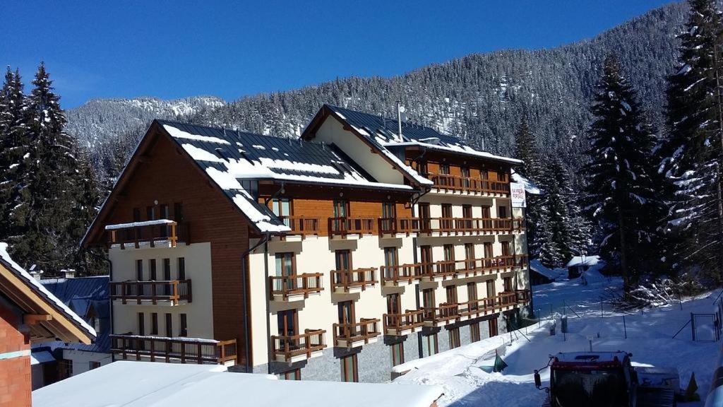 a large building with snow on top of it at Apartman Lúčky-Rea in Belá