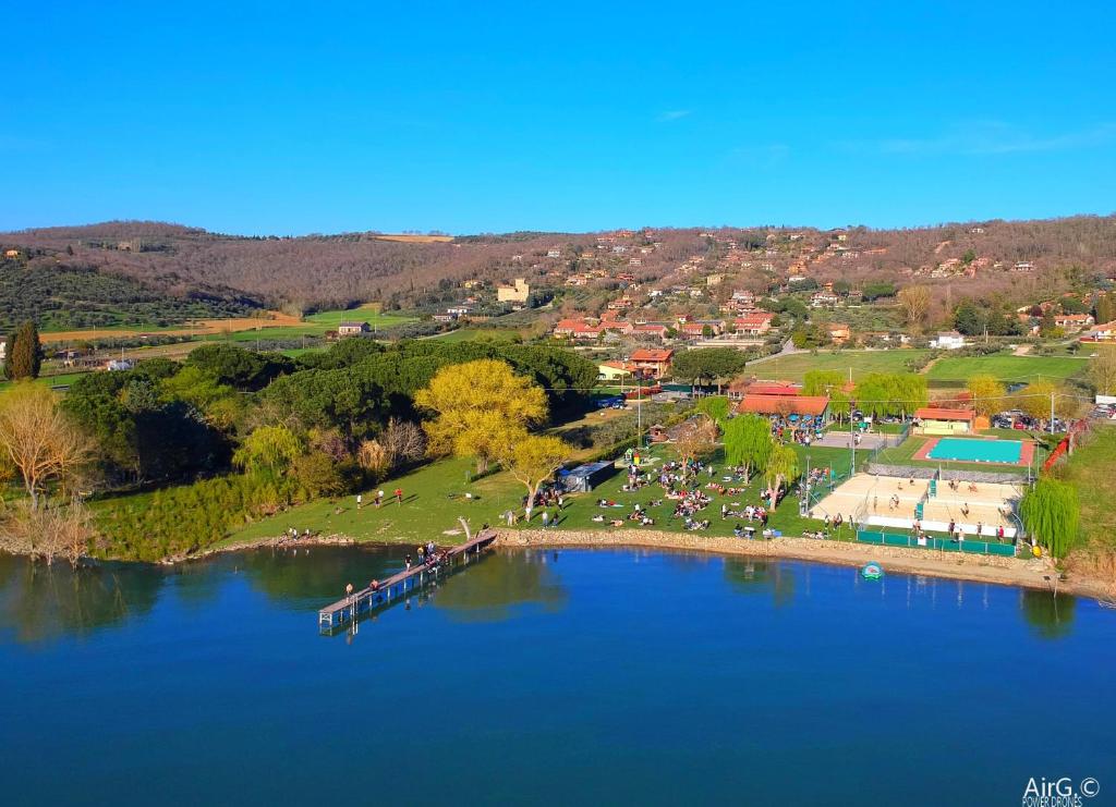 an aerial view of a lake with a group of people at Hotel Le Tre Isole in Magione