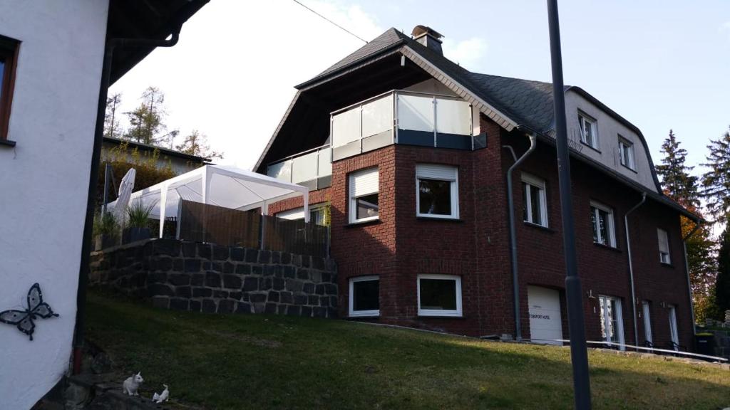 a large red brick house with a large window at Gaestehaus Savo in Nürburg