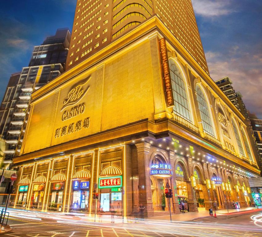a building on the corner of a street at night at Rio Hotel in Macau