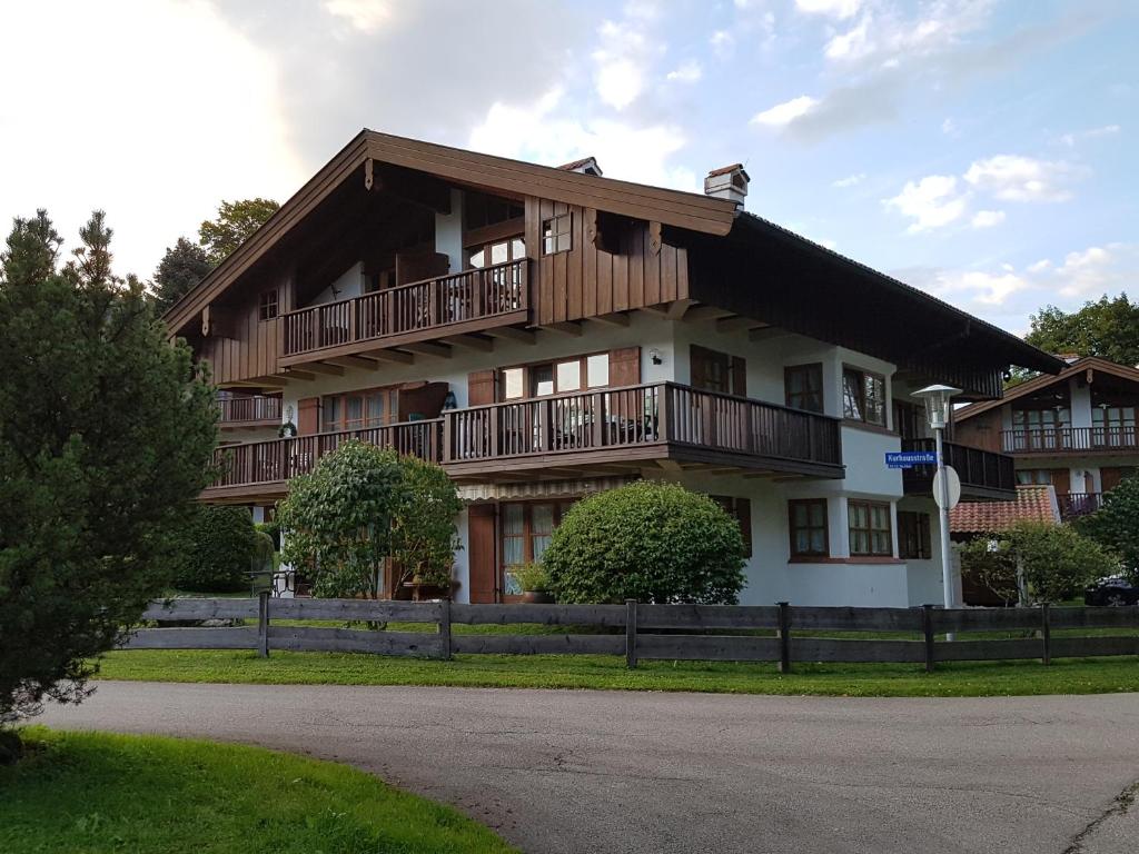 a large wooden building with a balcony at Fewo Sonntagshorn in Ruhpolding